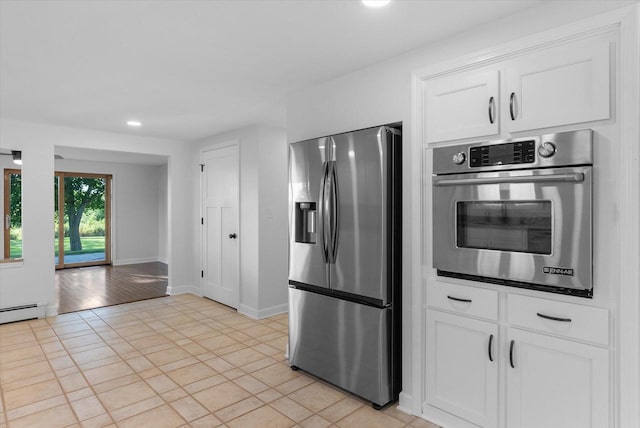 kitchen featuring appliances with stainless steel finishes, recessed lighting, white cabinets, and baseboards