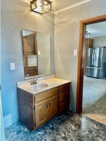 bathroom featuring vanity and ornamental molding