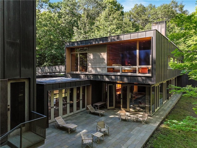 back of property with french doors and a patio area