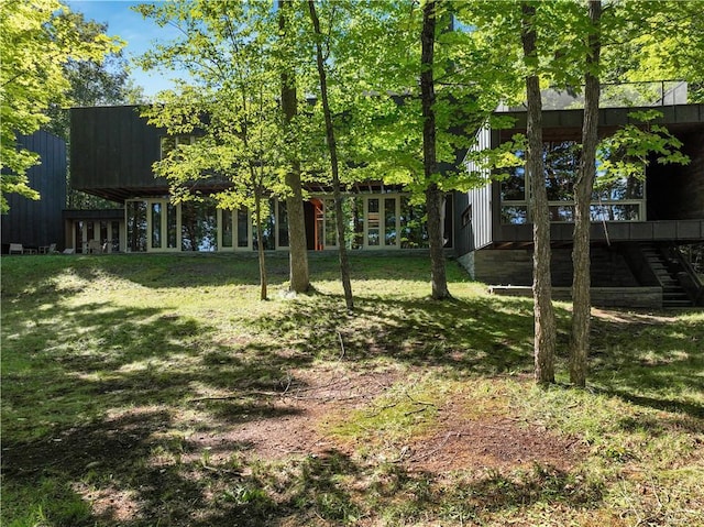 view of yard featuring stairway and french doors