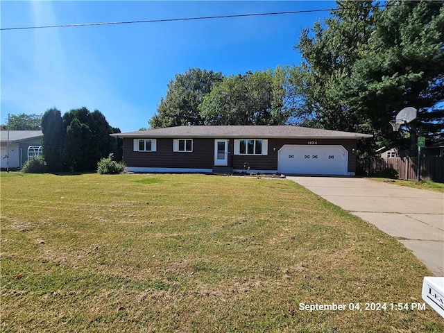 single story home with a front yard and a garage