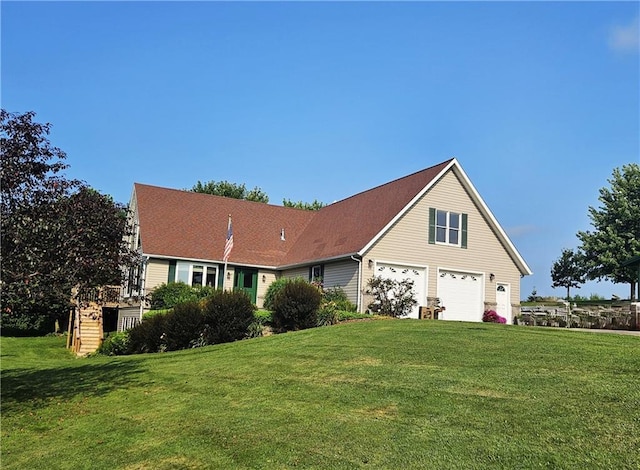 view of front of property featuring a garage and a front lawn