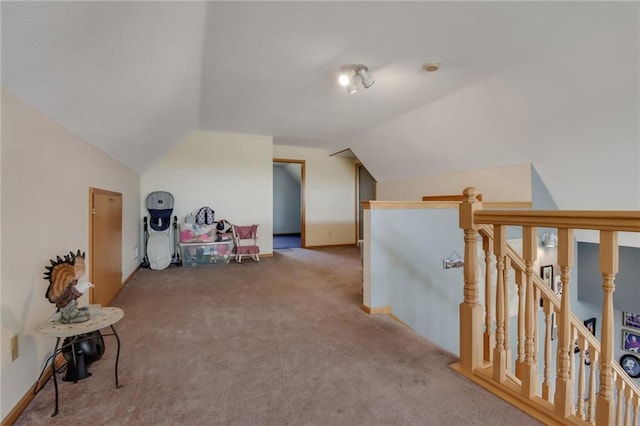 additional living space featuring lofted ceiling and carpet flooring