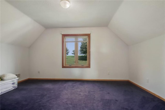 additional living space featuring lofted ceiling and carpet floors