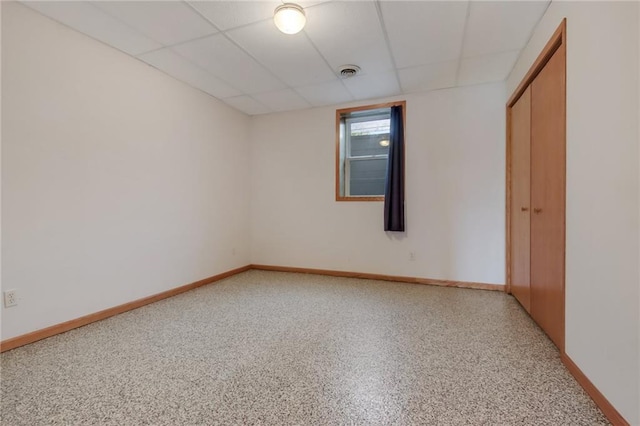 unfurnished room with a drop ceiling