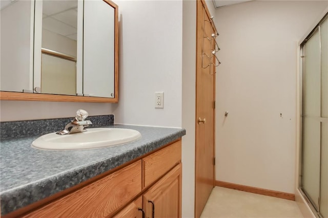 bathroom featuring vanity and a shower with shower door