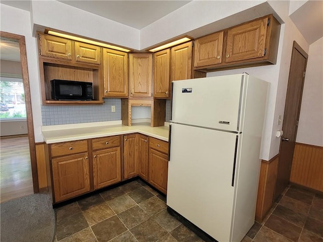 kitchen featuring white fridge and backsplash