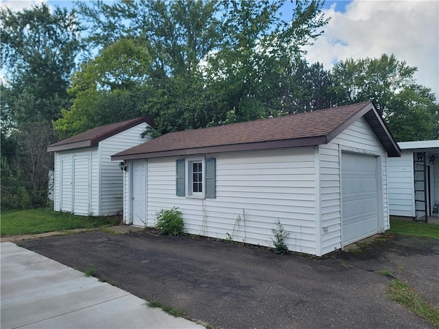 exterior space with a garage and an outdoor structure