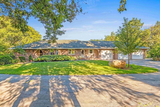 single story home featuring a garage and a front lawn