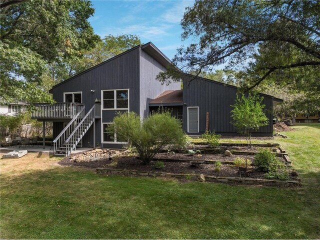 back of property featuring a patio, a yard, and a wooden deck