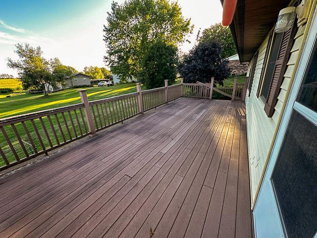 wooden deck with a lawn