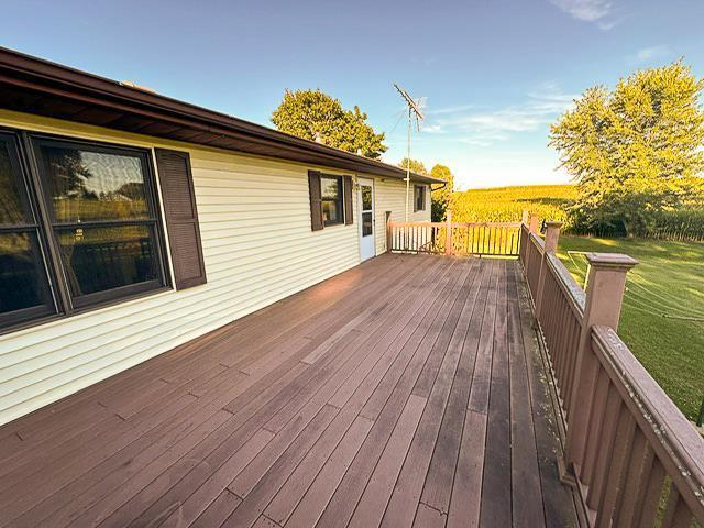 wooden terrace featuring a lawn