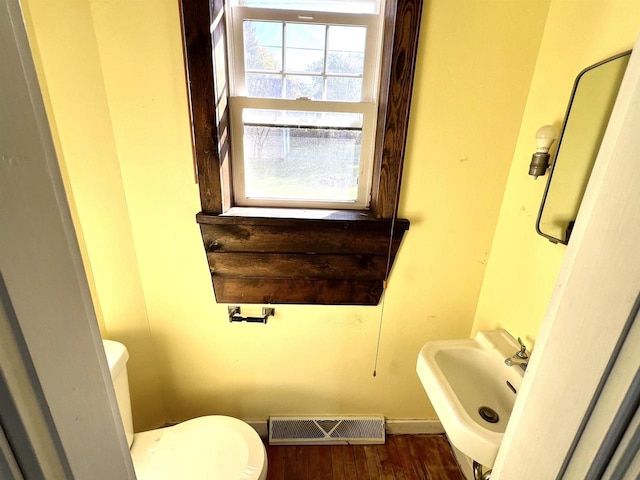 bathroom with sink, hardwood / wood-style floors, and toilet