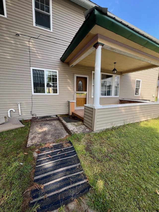 entrance to property with a lawn