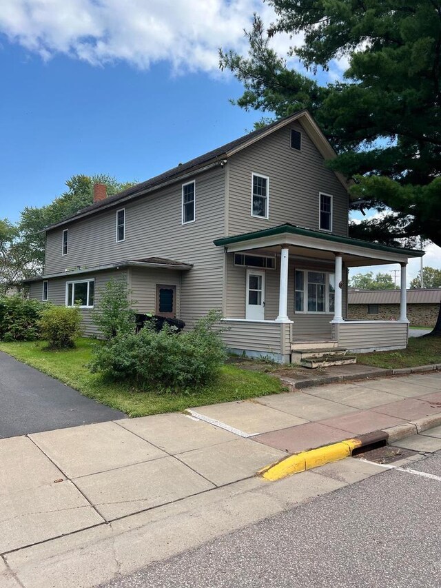 110 N Main St, Greenwood, WI 54437 - view of front of home featuring covered porch and a chimney