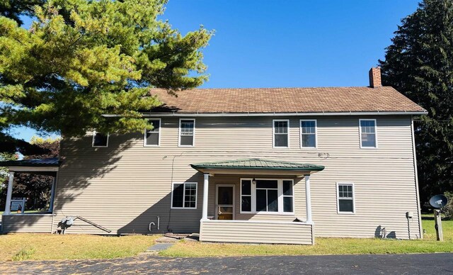 110 N Main St, Greenwood, WI 54437 - view of front facade featuring a chimney and a front lawn