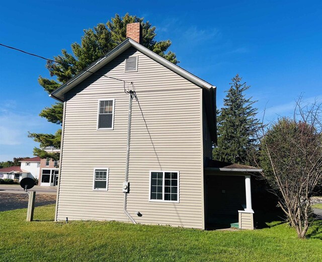 110 N Main St, Greenwood, WI 54437 - view of property exterior with a yard and a chimney