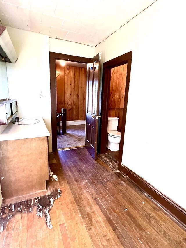 110 N Main St, Greenwood, WI 54437 - bathroom with vanity, toilet, and hardwood / wood-style floors