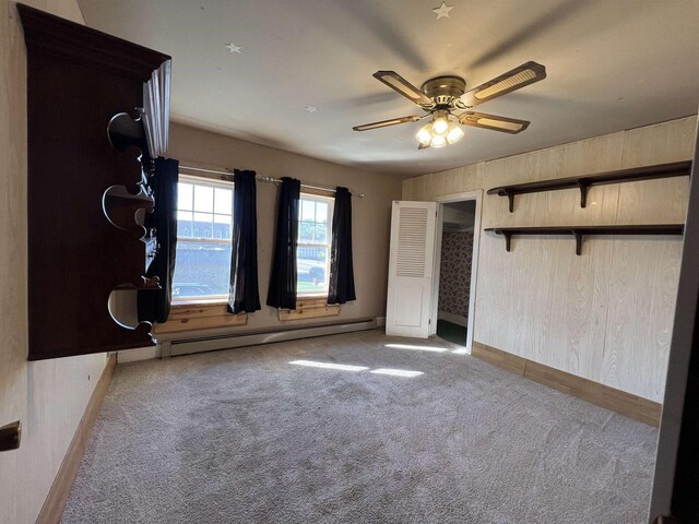 110 N Main St, Greenwood, WI 54437 - unfurnished bedroom with baseboards, a ceiling fan, carpet, and a baseboard heating unit