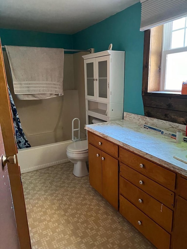110 N Main St, Greenwood, WI 54437 - full bathroom featuring tile patterned floors, vanity, toilet, and shower / tub combo