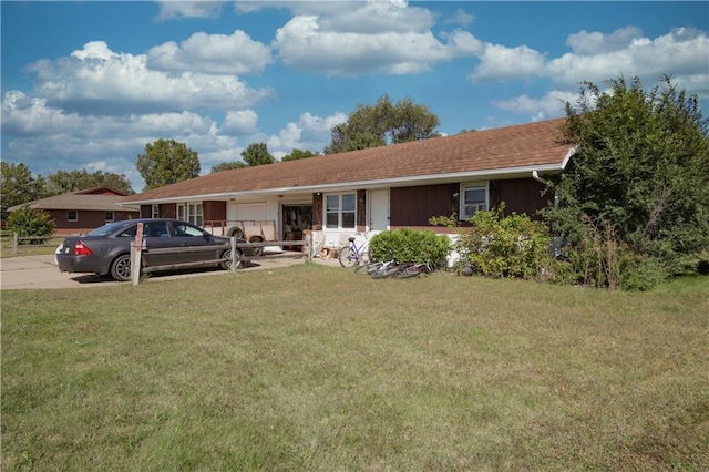 ranch-style home featuring a garage, driveway, and a front lawn