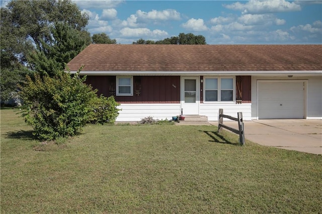 single story home with driveway, roof with shingles, an attached garage, entry steps, and a front lawn