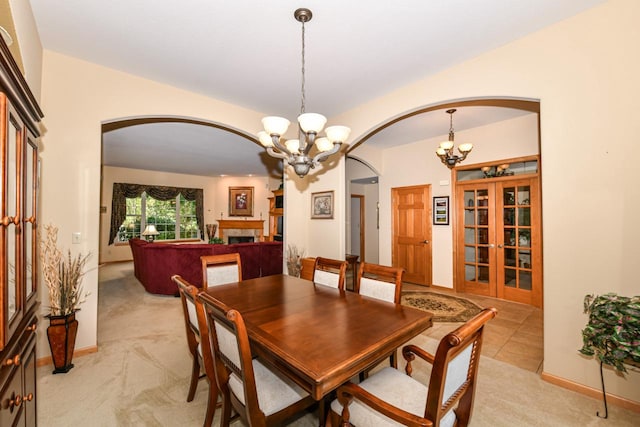 dining space featuring a notable chandelier and light carpet