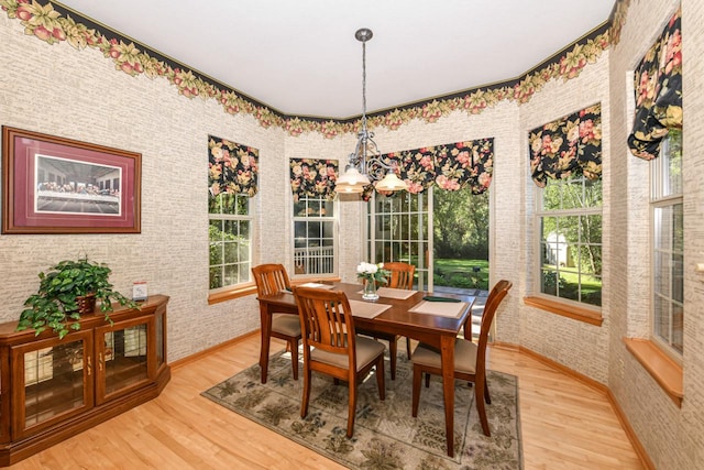 dining area with a chandelier and light hardwood / wood-style floors