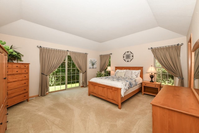 carpeted bedroom with lofted ceiling and access to outside