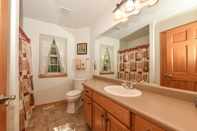 bathroom featuring toilet and vanity