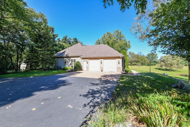 view of property exterior with a garage and a lawn