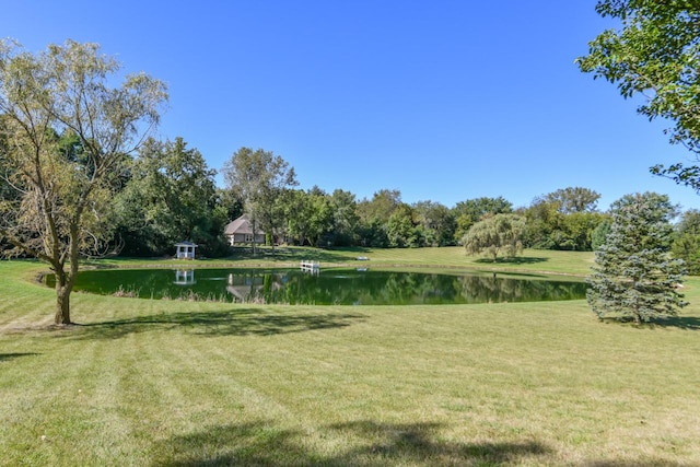 view of community with a lawn and a water view