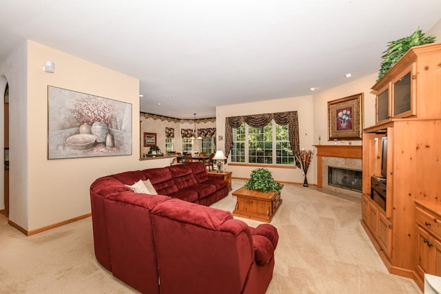 living room with a tiled fireplace and light carpet