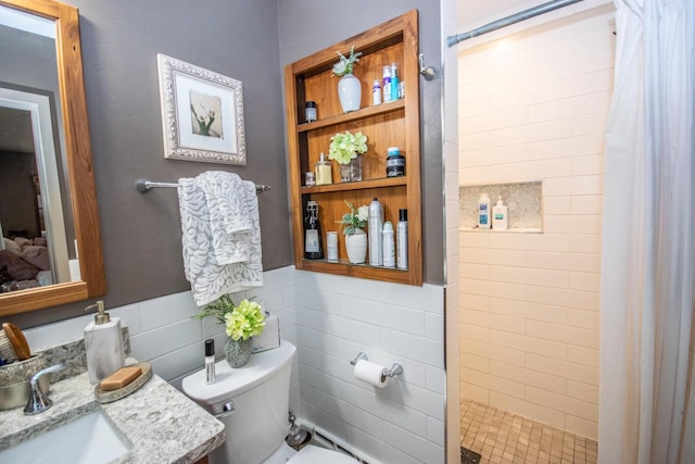 bathroom featuring a shower with shower curtain, toilet, tile walls, and vanity