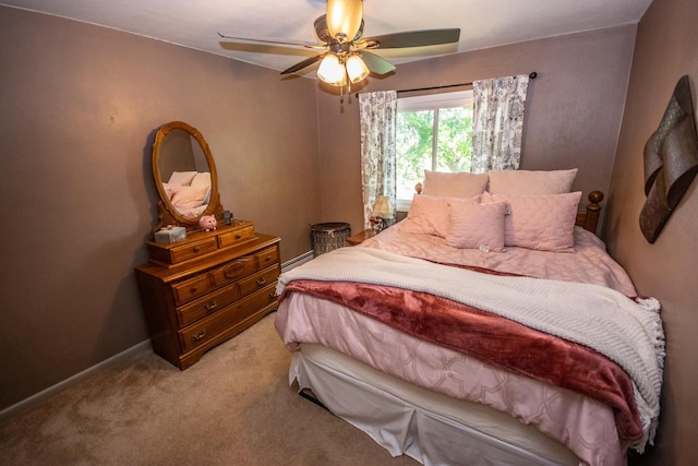 carpeted bedroom featuring ceiling fan and baseboard heating