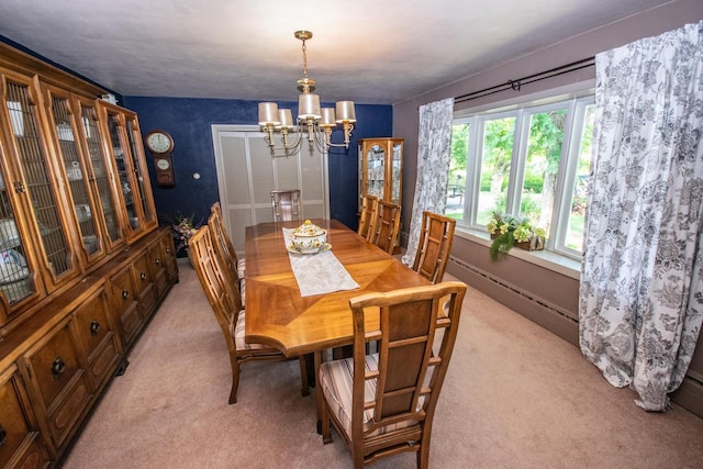 dining area with light colored carpet, a chandelier, and baseboard heating
