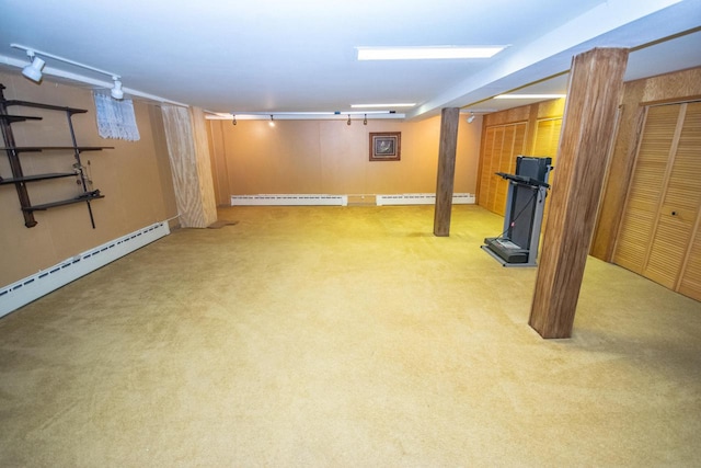 basement with a baseboard radiator and light colored carpet