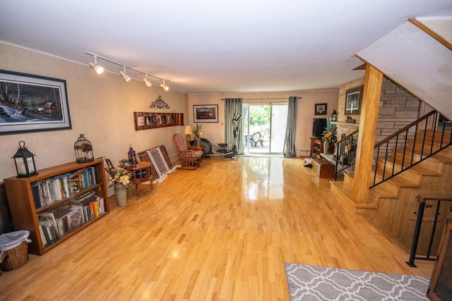 interior space with stairway, rail lighting, and wood finished floors