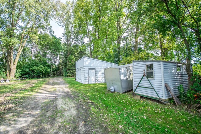 view of shed with dirt driveway
