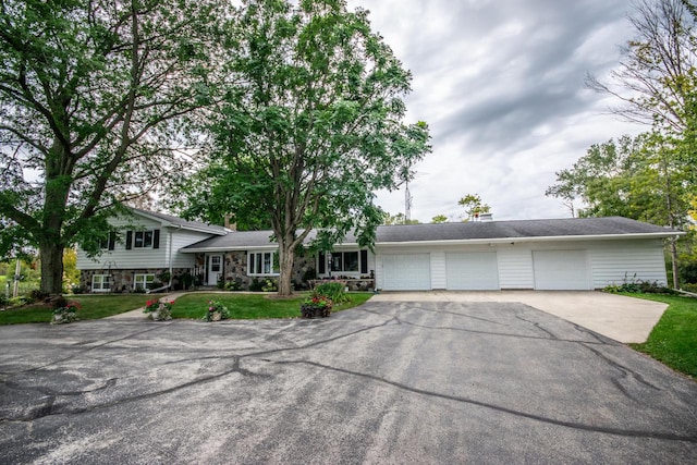 split level home with a front yard and a garage