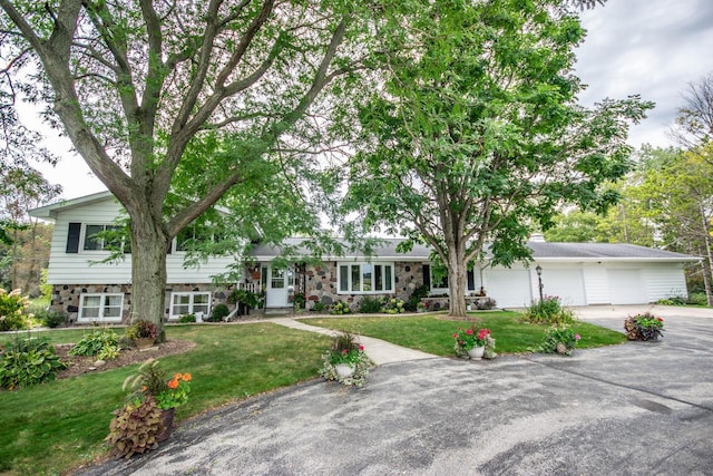 split level home with driveway and a front lawn