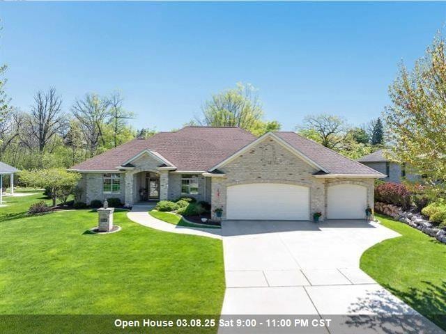 single story home with a garage, driveway, and a front yard