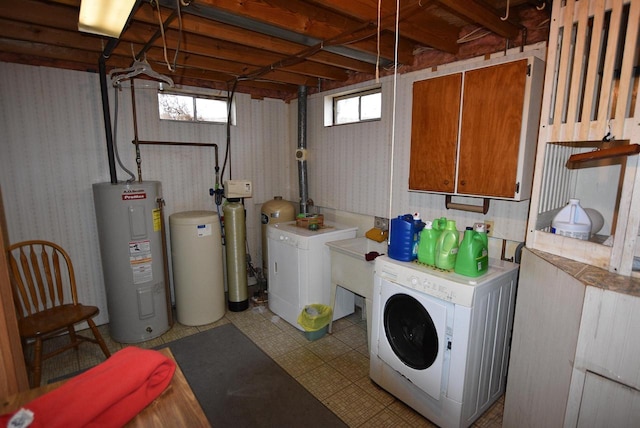 washroom with electric water heater and separate washer and dryer