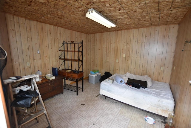 bedroom with wood walls