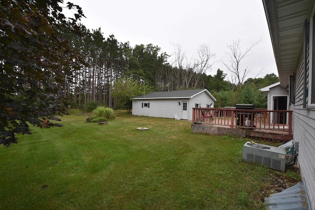 view of yard with an outdoor structure and a wooden deck