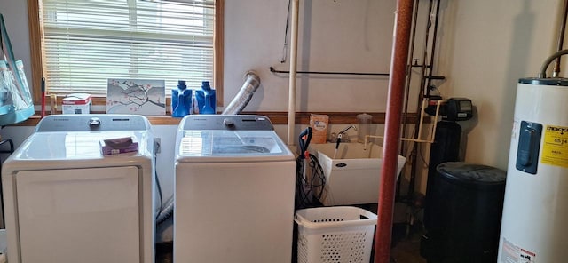 laundry room with separate washer and dryer, water heater, and sink