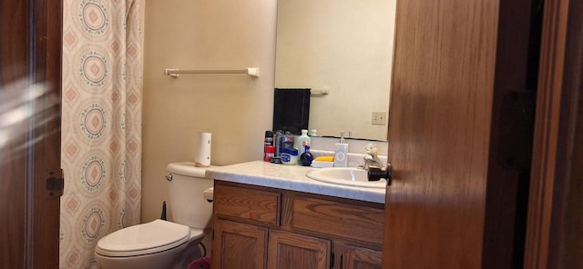 bathroom featuring toilet and vanity