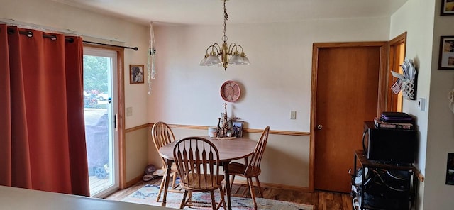 dining area with a notable chandelier and wood-type flooring