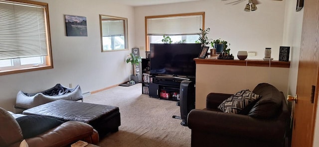 carpeted living room with a wealth of natural light and ceiling fan