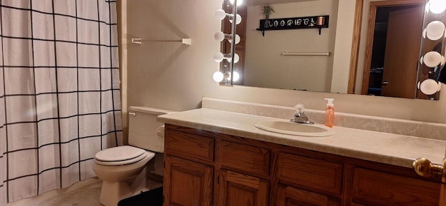 bathroom with vanity, toilet, and curtained shower